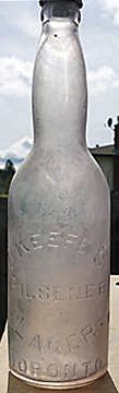 O'KEEFE'S PILSNER LAGER EMBOSSED BEER BOTTLE