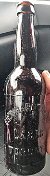 REINHARDT & COMPANY LAGEREMBOSSED BEER BOTTLE