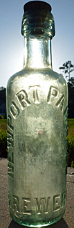 NEWPORT PAGNELL BREWERY COMPANY LIMITED EMBOSSED BEER BOTTLE