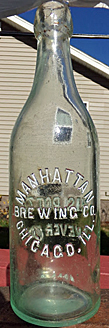 MANHATTAN BREWING COMPANY EMBOSSED BEER BOTTLE