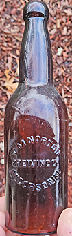 T. M. NORTON BREWING COMPANY EMBOSSED BEER BOTTLE