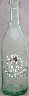 C. NOLL BOTTLER SCHLITZ BEER EMBOSSED BEER BOTTLE