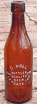 C. NOLL BOTTLER SCHLITZ BEER EMBOSSED BEER BOTTLE