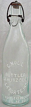 C. NOLL BOTTLER SCHLITZ BEER EMBOSSED BEER BOTTLE