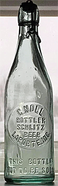 C. NOLL BOTTLER SCHLITZ BEER EMBOSSED BEER BOTTLE