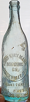 THE JOHN KUHLMANN BREWING COMPANY EMBOSSED BEER BOTTLE