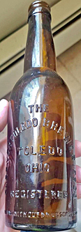 HUEBNER TOLEDO BREWERIES COMPANY EMBOSSED BEER BOTTLE