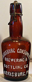 THE HARRISBURG CONSUMERS BREWING & BOTTLING COMPANY EMBOSSED BEER BOTTLE