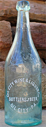 OIL CITY WINE AND LIQUOR COMPANY BOTTLERS OF BEER EMBOSSED BEER BOTTLE